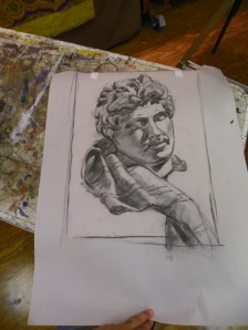 charcoal drawing taped to canvas