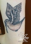 black and grey traditional bird tattoo