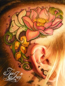lotus and flowers on head tattoo