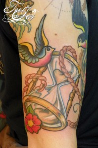 traditional bird and hourglass tattoo