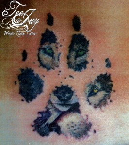 wolves inside pawprint tattoo
