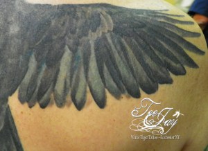 crow tattoo wing detail