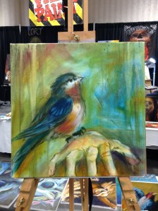 wip oil painting bird on hand