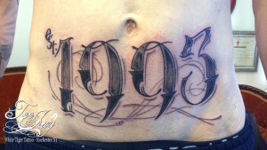 est 1993 stomach rocker tattoo