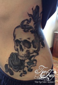 skulls and roses on side tattoo