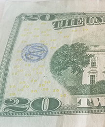 CND monogram stamp on $20