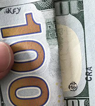 key stamp on $100 - CRA on $100 bill