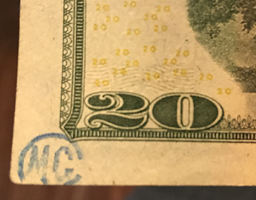 MC and circle stamp on $20